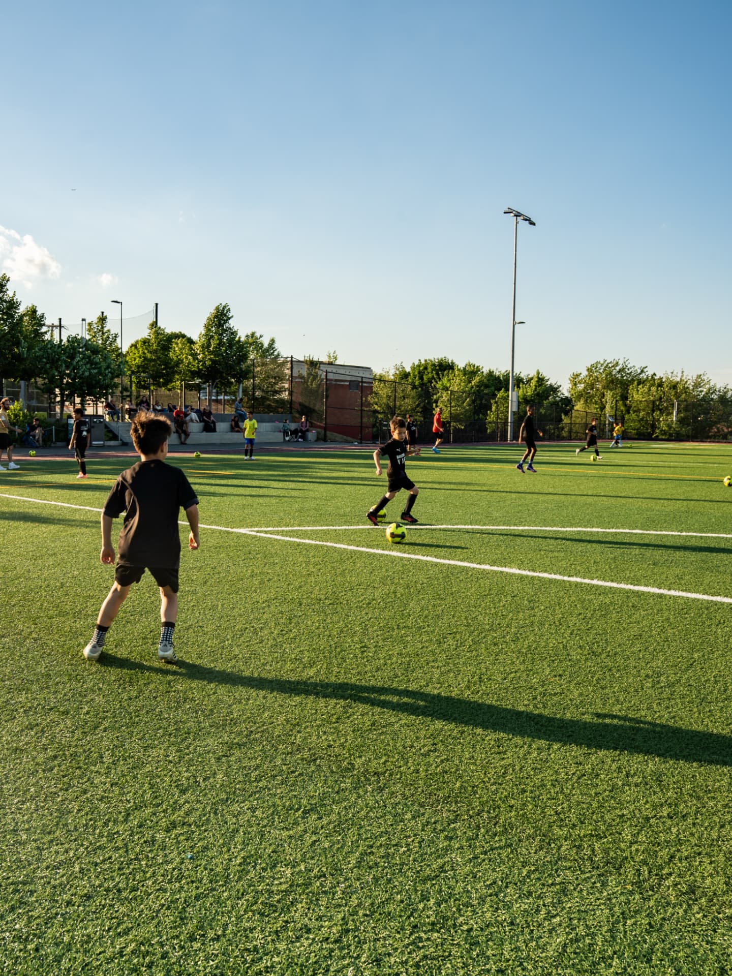 Vigor players passing across the turf field at golden hour